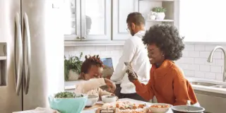 Picture of a girl in the kitchen with her dad.