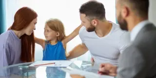 Picture of a family sitting around a table.